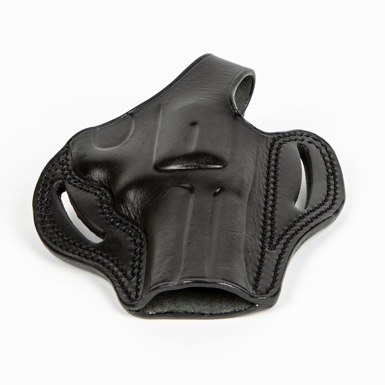 May include: A black leather holster for a handgun. The holster has a belt loop and a thumb break.