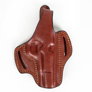 May include: A brown leather holster with a belt loop and stitching detail.