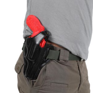 May include: A black leather holster with a red handgun inside. The holster is attached to a green belt.