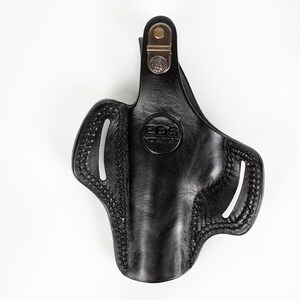 May include: Black leather holster with a brown metal clip and the text "EDS Holster" embossed on the front.