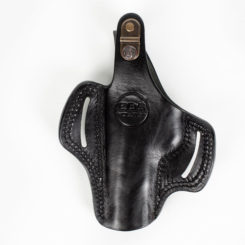 May include: Black leather holster with a brown metal clip and the text "EDS Holster" embossed on the front.