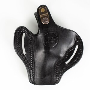 May include: Black leather holster with a brass snap and the text "EDS Holsters" embossed on the front.
