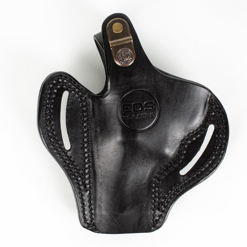 May include: Black leather holster with a brass snap and the text "EDS Holsters" embossed on the front.