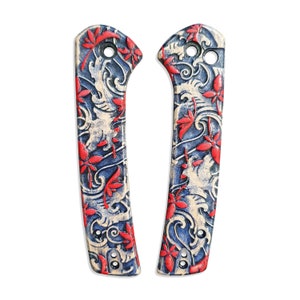 May include: A pair of knife scales with a blue and white floral pattern and red accents. The scales are made of a durable material and are designed to fit a variety of knife models.