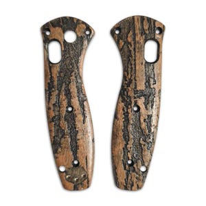 May include: A pair of brown and black patterned knife scales. The scales have a wood grain pattern and are made of a durable material.