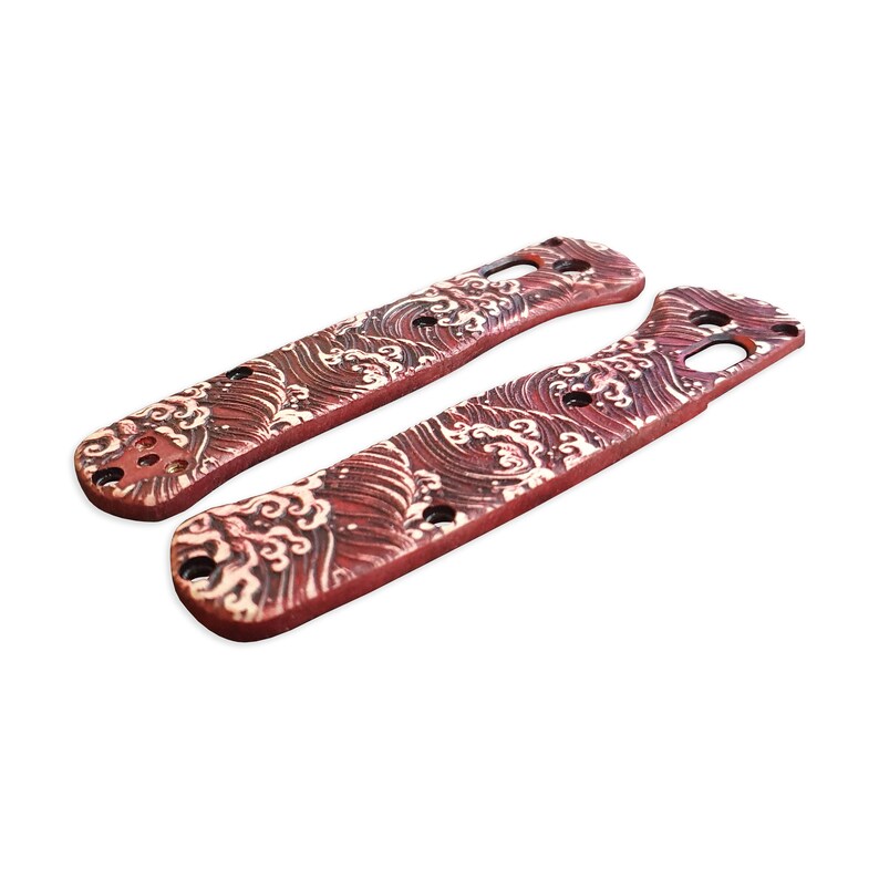 May include: A pair of red and white knife scales with a wave pattern. The scales are made of a durable material and are designed to fit a variety of knife models.