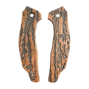 May include: A pair of brown and black knife scales with a wood grain pattern. The scales are made of a durable material and are designed to fit a variety of knife models.