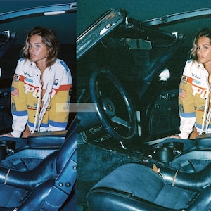 May include: A white, yellow, and blue racing-style jacket featuring the text "POLO" in large red letters across the chest, along with various embroidered patches including an American flag, worn by a person sitting inside a dark car interior.