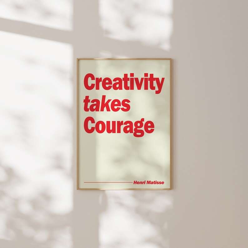 May include: A beige poster with a red quote that reads "Creativity takes Courage" by Henri Matisse.