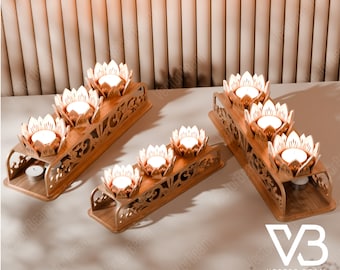 May include: Three wooden candle holders with intricate carvings and a lotus flower design. Each holder has four candle slots and a small candle in the center. The holders are arranged on a light brown surface.
