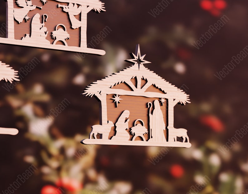 Puede incluir: Adorno navide&ntilde;o de madera que representa la escena de la natividad. El adorno presenta un establo de madera marr&oacute;n con techo de paja, una estrella en la parte superior y un pesebre en el interior. Las figuras de Mar&iacute;a, Jos&eacute; y el ni&ntilde;o Jes&uacute;s est&aacute;n cortadas en madera y colocadas dentro del establo. Tambi&eacute;n hay dos ovejas y un burro.