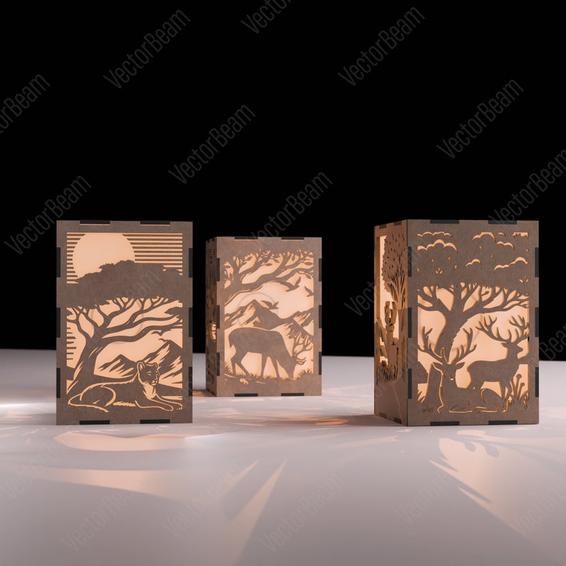 May include: Three wooden lamp bases featuring intricate cut-out designs depicting a lion, deer, and a deer with a fawn in a woodland setting. The lamps are illuminated from within, casting a warm glow.