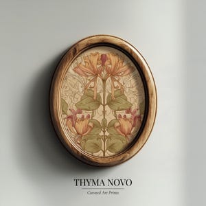 May include: Oval wooden framed art print featuring a symmetrical floral design in shades of peach, orange, and green. The artwork has a vintage aesthetic, with the text "THYMA NOVO" and "Curated Art Prints" at the bottom.