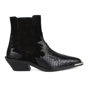 May include: Black suede and snakeskin cowboy boots with a pointed toe and a stacked heel.