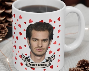 May include: White ceramic mug with a red heart pattern and a photo of Andrew Garfield. The mug has the text "Andrew Garfield" on a banner.