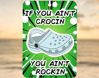 May include: Green and black comic book style car air freshener with a white cartoon clog shoe and the text "If you ain't crocin you ain't rockin".