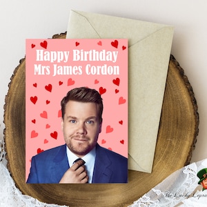 May include: A pink card with the text "Happy Birthday Mrs James Cordon" and a photo of James Cordon. The background is filled with red hearts.