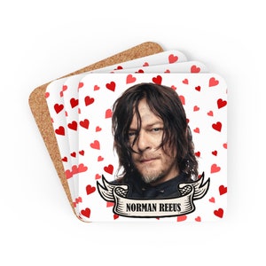 May include: A set of four white coasters with a red heart pattern. The coasters feature a photo of Norman Reedus with a black and white banner that says "Norman Reedus".