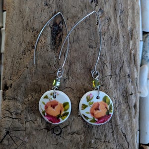 Handmade upcycled vintage floral plate earrings combined with stainless steel ear wires and green beads.