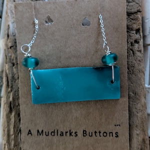 Handmade teal stained glass pendant necklace combined with handmade lampwork beads and stainless steel chain.