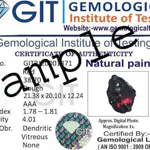 May include: A Gemological Institute of Testing (GIT) certificate for a natural painite gemstone. The document details the gem's colour, weight (38.70), shape, measurements (21.38 x 20.10 x 12.24 mm), and grade (AAA). Includes a photo of the stone.