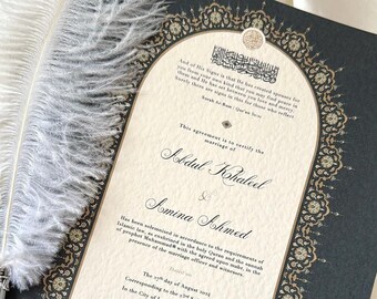 May include: A black and gold Islamic marriage certificate with ornate borders. The text reads "This agreement is to certify the marriage of Abdul Khaleel & Amina Ahmed." The date of the marriage is August 3034, corresponding to the 23rd Safar 1446 ah in the City of London, United Kingdom. The text also includes a quote in Arabic.