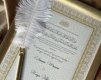 May include: A framed Islamic wedding certificate with gold calligraphy and a white feather pen. The text reads "In the name of Allah, the Most Gracious and the Most Merciful." and "This agreement was made on 15th August 2024 corresponding to 14th Safar, 1416 AH to certify the marriage of Amaan Wascem & Roya Khan."