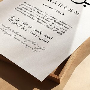 May include: A white framed print with black text. The text includes the Arabic word "Ibrahim" and the English translation "IBRAHEEM". The date "19/08/2015" is also included. The text below explains the meaning of the name Ibrahim in the Quran.
