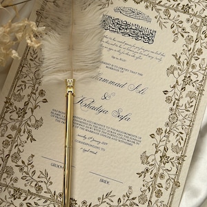K&ouml;nnte beinhalten: Eine traditionelle islamische Heiratsurkunde mit goldenen floralen Mustern und Kalligraphie. Die Urkunde besagt, dass die Ehe von Mammad Ali und Khadija Safa gem&auml;&szlig; den Anforderungen des Heiligen Korans und der Sunna bescheinigt wird. Das Datum der Heirat ist Samstag, der 14. Januar 2024, entsprechend dem 7. Jumad al-Awwal 1445.