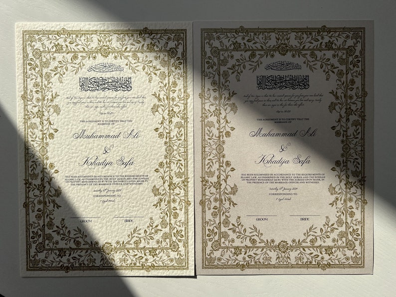 May include: Two ivory-coloured wedding certificates with gold floral borders. The text reads "This Agreement is to Certify that the Marriage of Muhammad Ali & Khadidja Safa has been solemnized in accordance with the Religious Rites of Prophet Muhammad (SAW) with the Holy Quran and Sunnah in the presence of the Marriage Officer and Witnesses.  Saturday 8th January 2017. Corresponding to 7th Jumada Al-Awwal 1438."
