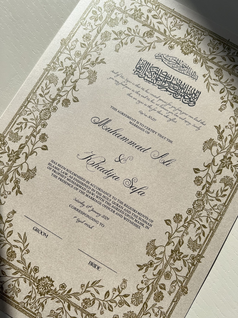 May include: A formal marriage certificate with a gold floral border and Arabic calligraphy. The text reads "This agreement is to certify that the marriage of Muhammad Ali & Khadija Safa has been solemnised in accordance to the requirements of Islamic law, as enshrined in the Holy Quran and the Sunnah of Prophet Muhammad (SAW) with the agreed upon mahr, in the presence of the marriage officer and witnesses. Saturday 13 January 2029 corresponding to Rajab 1441".