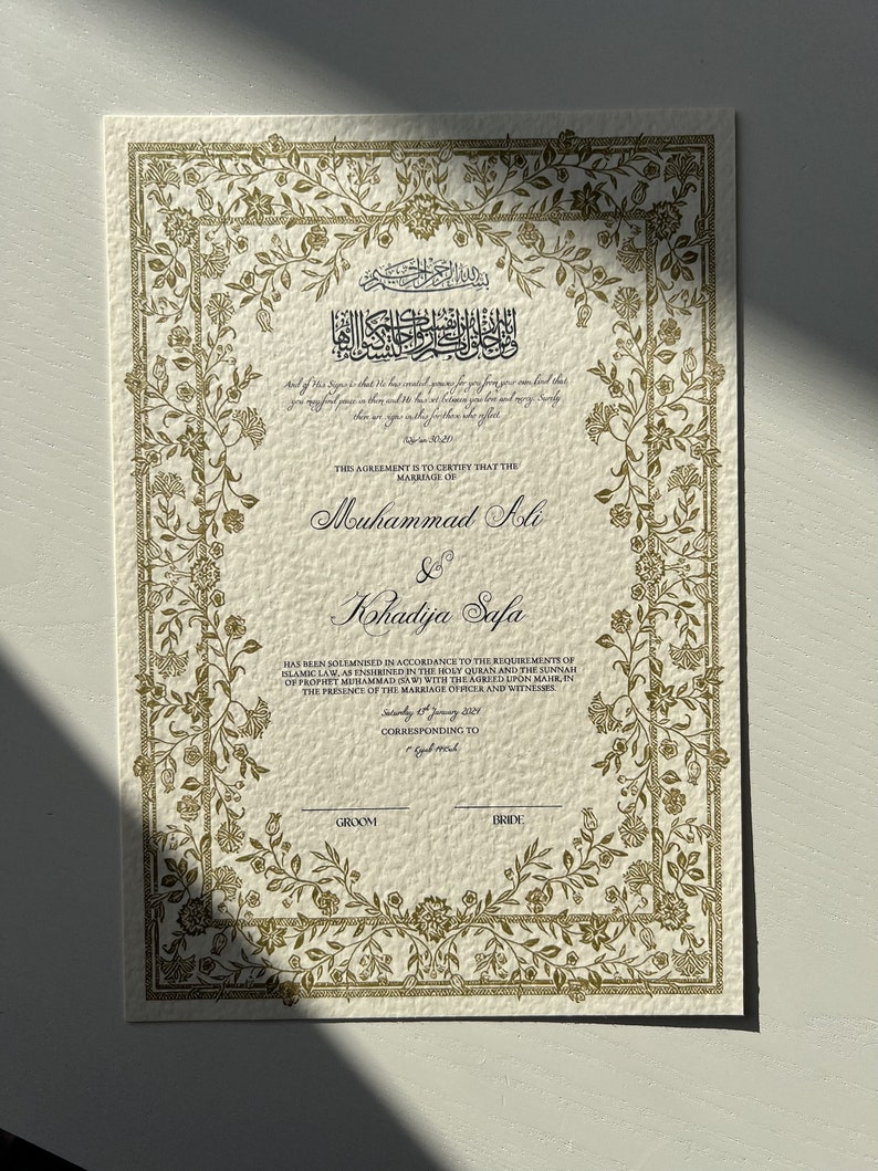 May include: A traditional Islamic marriage certificate with ornate gold floral borders. The text reads "This agreement is to certify that the marriage of Muhammad Ali & Khadija Safa has been solemnised in accordance to the requirements of Islamic Law, as enshrined in the Holy Quran and the Sunnah of Prophet Muhammad (SAW) with the agreed upon mahr, in the presence of the marriage officer and witnesses. Saturday 6th January 2020. Corresponding to..."