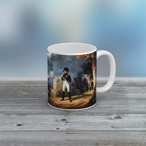 May include: White ceramic coffee mug featuring a colourful image of a man in military uniform standing in front of a horse and soldiers. The image is set against a cloudy sky and a forest background.