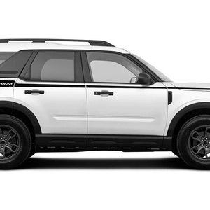 May include: White SUV with black accents and black wheels. The word "Bronco" is displayed in black script on the rear side panel, accompanied by black stripes. The vehicle has a black roof rack and black trim.