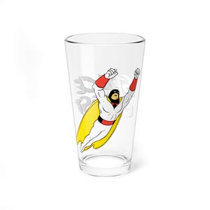May include: A clear pint glass featuring a cartoon image of a superhero in a white suit, red gloves, and a black mask, with a yellow cape. The superhero is in a flying pose. The glass has the words "Space Ghost" in a faded font.