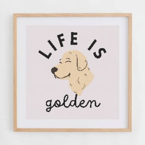 Puede incluir: Un estampado enmarcado con las palabras "LIFE IS golden" en letras negras. La imagen presenta una ilustración de un perro golden retriever sonriente en color beige claro. El marco es de madera marrón claro.