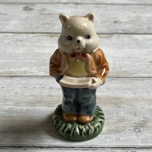 Vintage ceramic bear holding newspaper