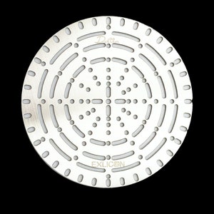 May include: A silver shower head with a circular design featuring multiple small holes and a larger central hole. The shower head has the text "Dotter" and "EXLICON" printed on it.