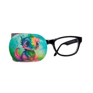 May include: A black eye patch with a colorful cartoon dragon design. The patch is attached to a pair of black eyeglasses.