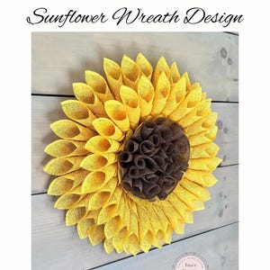 May include: A yellow and brown sunflower wreath made of burlap. The wreath is on a wooden background. The text "Tina's Country Door" is visible in the bottom right corner of the image.