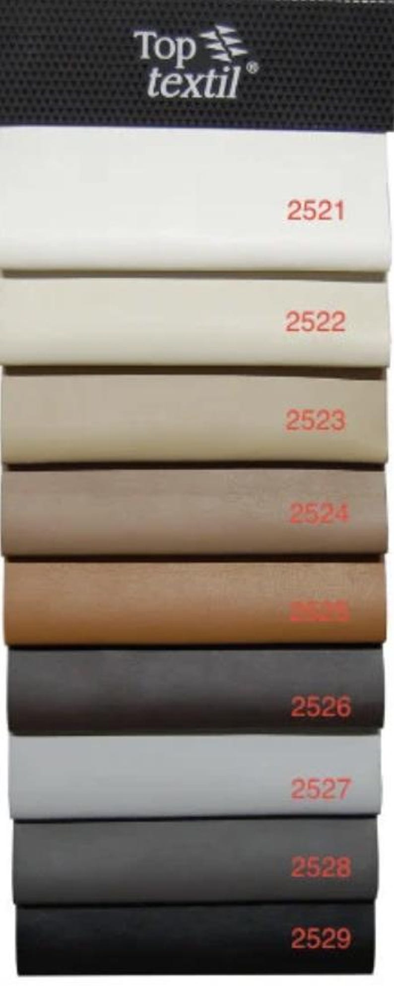 May include: A color swatch display featuring samples of fabric in various shades. The samples range from white to black, with each color labeled with a number. The top of the display has the "Top textil" logo.
