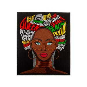 May include: Black patch featuring a stylized illustration of a woman with brown skin, wearing gold-rimmed glasses and hoop earrings. Her hair is adorned with words like "Queen," "Proud," and "Gifted."