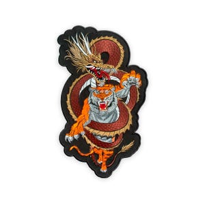 May include: Embroidered patch featuring a dragon and tiger design. The dragon is brown and gold, with a red tongue and white whiskers. The tiger is orange and gray, with its claws extended. The patch has a black border.