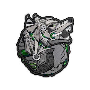 May include: An embroidered patch featuring a stylized robotic wolf head in profile. The design uses shades of grey, black, and white thread with vibrant green accents, depicting mechanical components, gears, and sharp teeth on a dark background.