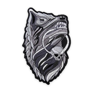 May include: Embroidered patch featuring a wolf's head with a skull and ring design. The patch is primarily black, gray, and white, with detailed stitching. The wolf's mouth is open, revealing sharp teeth. The patch is likely for jackets, bags, or other apparel.