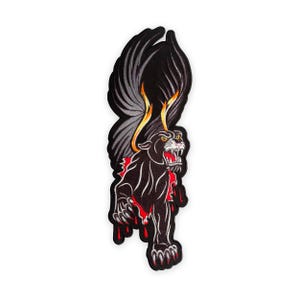 May include: Embroidered patch featuring a black panther with red accents and flames. The panther has a fierce expression, with its mouth open, and is depicted with large, stylized wings. The patch is designed with a traditional tattoo aesthetic.