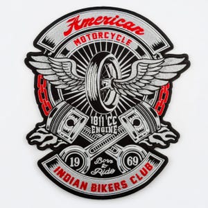 May include: Embroidered patch with a motorcycle theme. The patch features a wheel with wings, pistons, and the text "American Motorcycle Indian Bikers Club." The design includes red, white, and black colours, with the text "Born to Ride" in the centre.