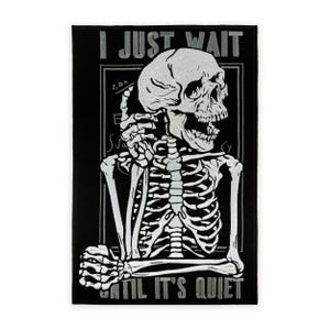 May include: Black rectangular patch featuring a white skeleton holding a phone to its head. The text "I JUST WAIT" is at the top, and "UNTIL IT'S QUIET" at the bottom. The skeleton is in a seated position.