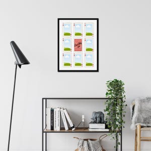 May include: A framed artwork featuring playing cards. Nine cards are arranged around a central card with the text "Lucky me". The cards have a white background with a landscape scene and a playing card suit symbol.
