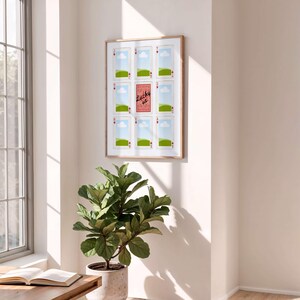 May include: A framed wall art piece featuring playing card designs. The artwork includes nine playing cards with the suits of hearts and a central card that reads "Lucky us". The frame is a light brown color.